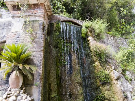 The falls in mountains flow from above and rustle