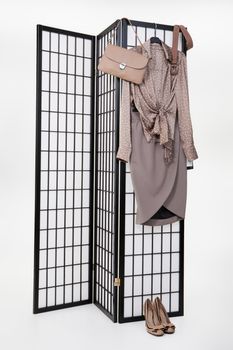 Woman's clothing hanging on the folding screen