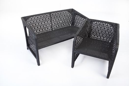 Suite of wicker furniture made of synthetic fibre on isolated background