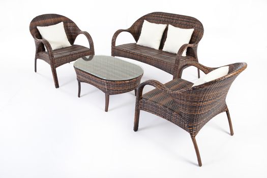 Suite of wicker furniture made of synthetic fibre on isolated background
