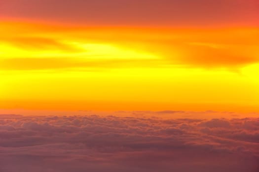 Sunset with clouds over view from airplane flying