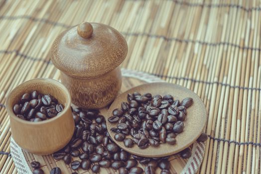 Coffee beans and coffee cup set on bamboo wooden background.Photo in retro color image style, Soft focus.