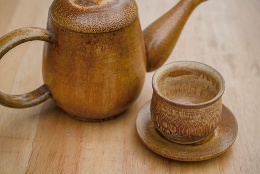 Cup of tea and teapot on wooden desk