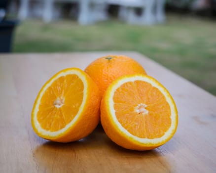 Slice of orange on wooden table.