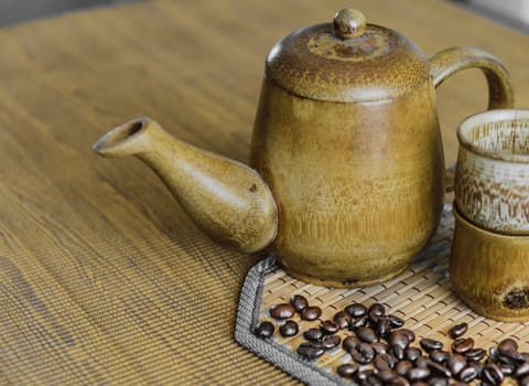 Soft focus image of coffee beans and coffee cups set on wooden background.Vintage style.(soft focus)