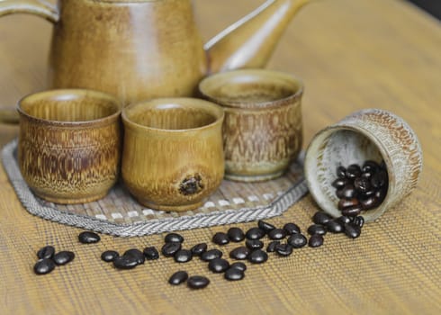 Soft focus image of coffee beans and coffee cups set on wooden background.Vintage style.(soft focus)