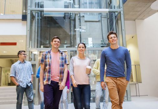 education, high school, friendship, drinks and people concept - group of smiling students with paper coffee cups