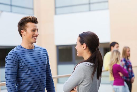 friendship, people and education concept - group of smiling students outdoors