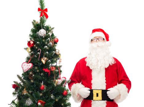 holidays and people concept concept - man in costume of santa claus with christmas tree