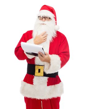 christmas, holidays and people concept - man in costume of santa claus with notepad