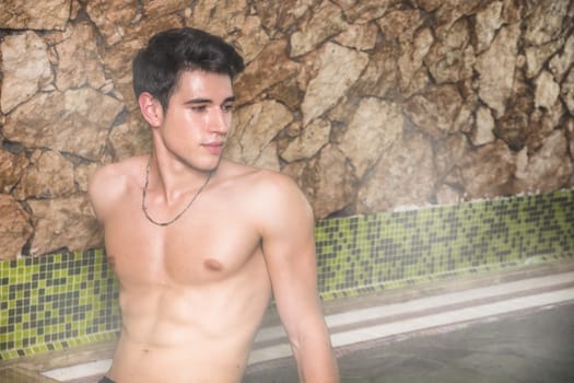 Young Shirtless Man Gazing Seductively at Camera and Relaxing in Steam Sauna - Turkish Bath - Sweating