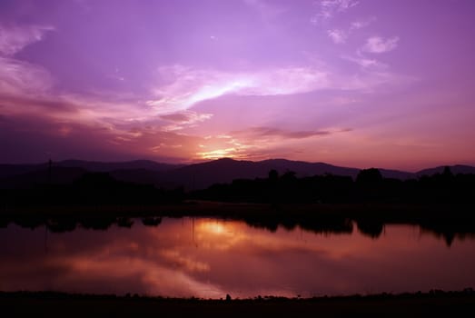 Cloud sky and sunbeam with lake and mountain background