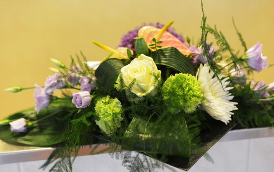 flower arangement in green yellow and pink with roses and carnation