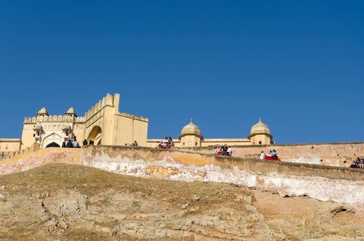Jaipur, India - December 29, 2014: Tourists enjoy elephant ride in the Amber Fort on December 29, 2014, Amber Fort was built by Raja Man Singh I  in Jaipur, Rajasthan, India.