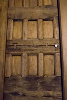 wooden door restored of brown color with cylinder lock