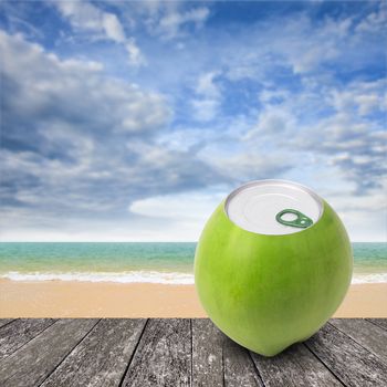 Fresh coconut with can open tool on top and sea background