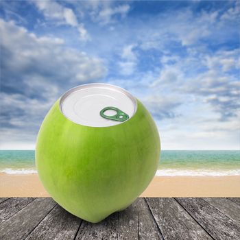 Fresh coconut with can open tool on top and sea background