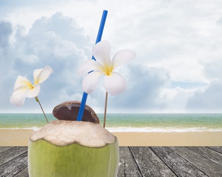 Fresh coconut drink with nice beach background
