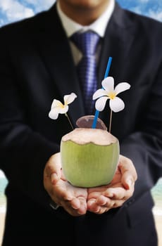 Businessman offer coconut drink at beside beach, Drinks business