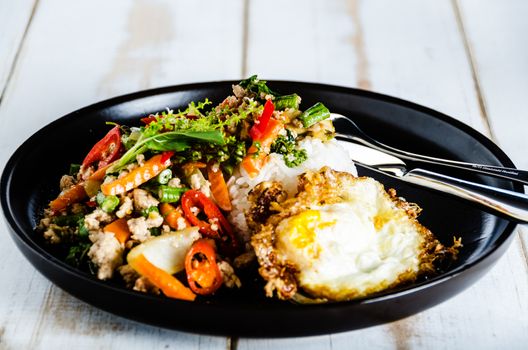 Thai spicy food basil pork fried with rice and fried egg ,Pad Kra Phao moo