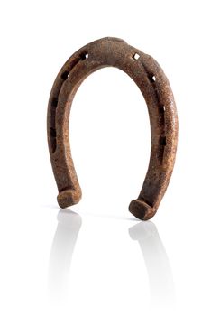 Old rusty horse shoe on white.