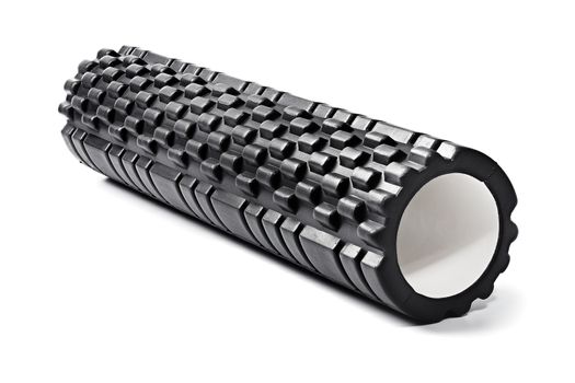 A black bumpy foam massage roller. Foam rolling is a self-myofascial release technique that is used by athletes and physical therapists to inhibit overactive muscles.