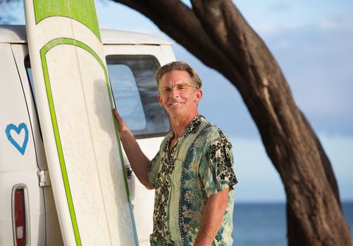 Cute and confident surfer with eyeglasses outdoors