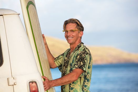 Happy single adult with his surfboard in Hawaii