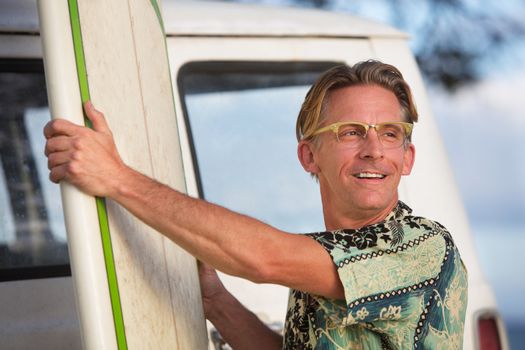 Handsome single Caucasian male with his surfboard in Hawaii