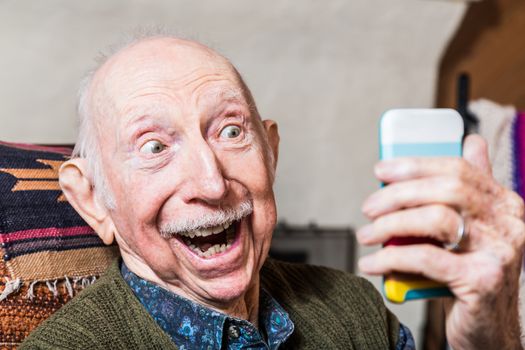 Elderly gentleman taking a selfie with smartphone