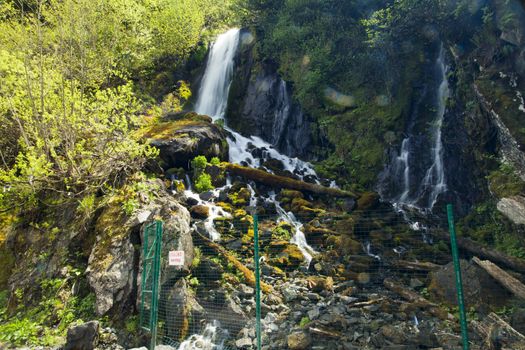 The falls in mountains flow from above and rustle