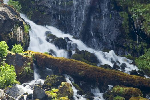 The falls in mountains flow from above and rustle