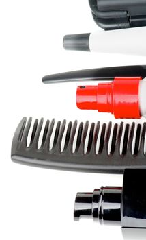 Frame of Black Comb and Various Hair Styling and Curling Products isolated on white background