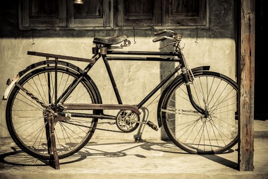 Vintage bicycle parking at old house in retro color style, Thailand