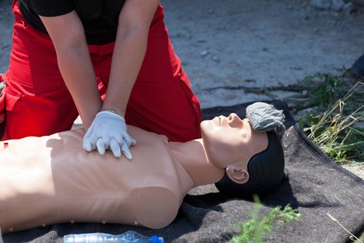 First aid training. CPR being performed on a medical-training manikin. 