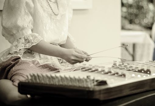 Hand play Thai wooden dulcimer musical instrument in vintage color style