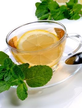   Cup of tea with a slice of lemon, mint and cinnamon