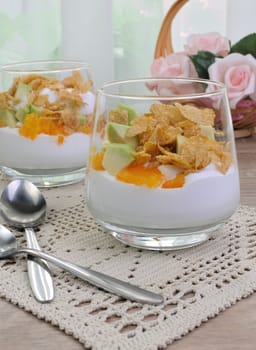 Parfait with slices of orange, avocado and flakes