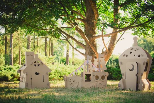 Eco-friendly toys made of cardboard ship, a house and a spaceship. Summer day. Eco concept