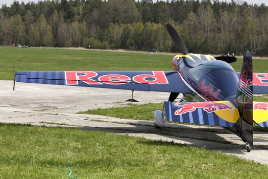 Plasy, Czech Republic - April 27, 2013: Peter Besenyei from Hungary on the Airshow "The Day on Air". His aircraft is painted in the colors of Red Bull energy drink for sponsorship reasons