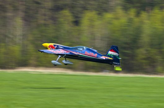 Plasy, Czech Republic - April 27, 2013: Peter Besenyei from Hungary on the Airshow "The Day on Air". His aircraft is painted in the colors of Red Bull energy drink for sponsorship reasons