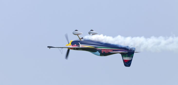 Plasy, Czech Republic - April 27, 2013: Peter Besenyei from Hungary on the Airshow "The Day on Air". His aircraft is painted in the colors of Red Bull energy drink for sponsorship reasons