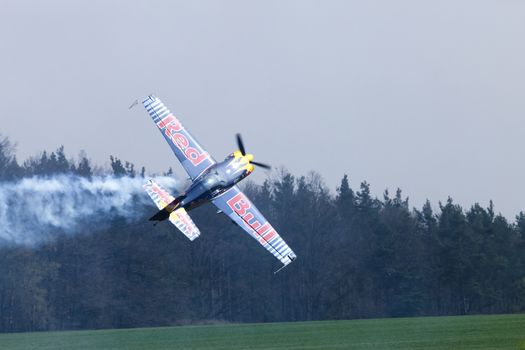 Plasy, Czech Republic - April 27, 2013: Peter Besenyei from Hungary on the Airshow "The Day on Air". His aircraft is painted in the colors of Red Bull energy drink for sponsorship reasons