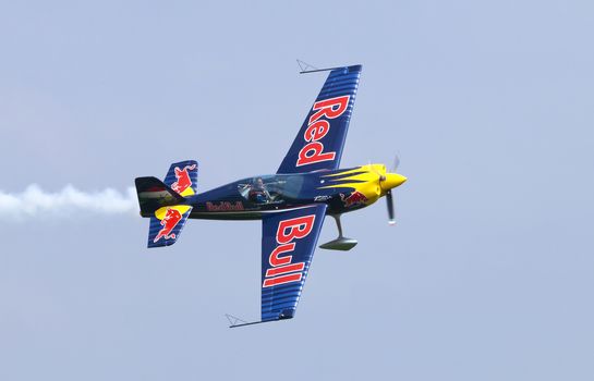 Plasy, Czech Republic - April 27, 2013: Peter Besenyei from Hungary on the Airshow "The Day on Air". His aircraft is painted in the colors of Red Bull energy drink for sponsorship reasons