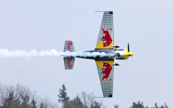 Plasy, Czech Republic - April 27, 2013: Peter Besenyei from Hungary on the Airshow "The Day on Air". His aircraft is painted in the colors of Red Bull energy drink for sponsorship reasons