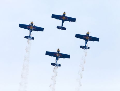 Plasy, Czech Republic - April 27, 2013: The Flying Bulls Aerobatics Team on the Airshow "The Day on Air". The team fly four modified Zlin Z-50 LX aircraft, painted in the colors of Red Bull energy drink for sponsorship reasons