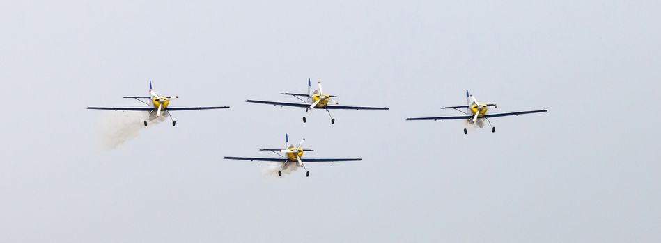 Plasy, Czech Republic - April 27, 2013: The Flying Bulls Aerobatics Team on the Airshow "The Day on Air". The team fly four modified Zlin Z-50 LX aircraft, painted in the colors of Red Bull energy drink for sponsorship reasons