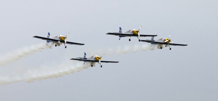 Plasy, Czech Republic - April 27, 2013: The Flying Bulls Aerobatics Team on the Airshow "The Day on Air". The team fly four modified Zlin Z-50 LX aircraft, painted in the colors of Red Bull energy drink for sponsorship reasons