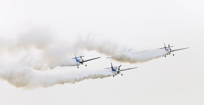 Plasy, Czech Republic - April 27, 2013: The Flying Bulls Aerobatics Team on the Airshow "The Day on Air". The team fly four modified Zlin Z-50 LX aircraft, painted in the colors of Red Bull energy drink for sponsorship reasons