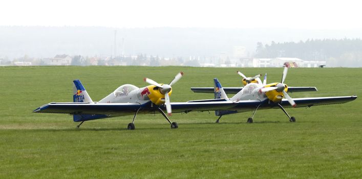 Plasy, Czech Republic - April 27, 2013: The Flying Bulls Aerobatics Team on the Airshow "The Day on Air". The team fly four modified Zlin Z-50 LX aircraft, painted in the colors of Red Bull energy drink for sponsorship reasons